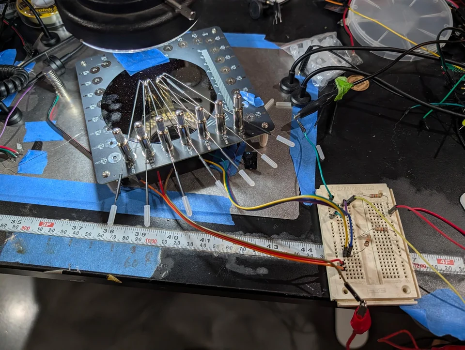 A wafer connected to a breadboard measurement setup with test leads