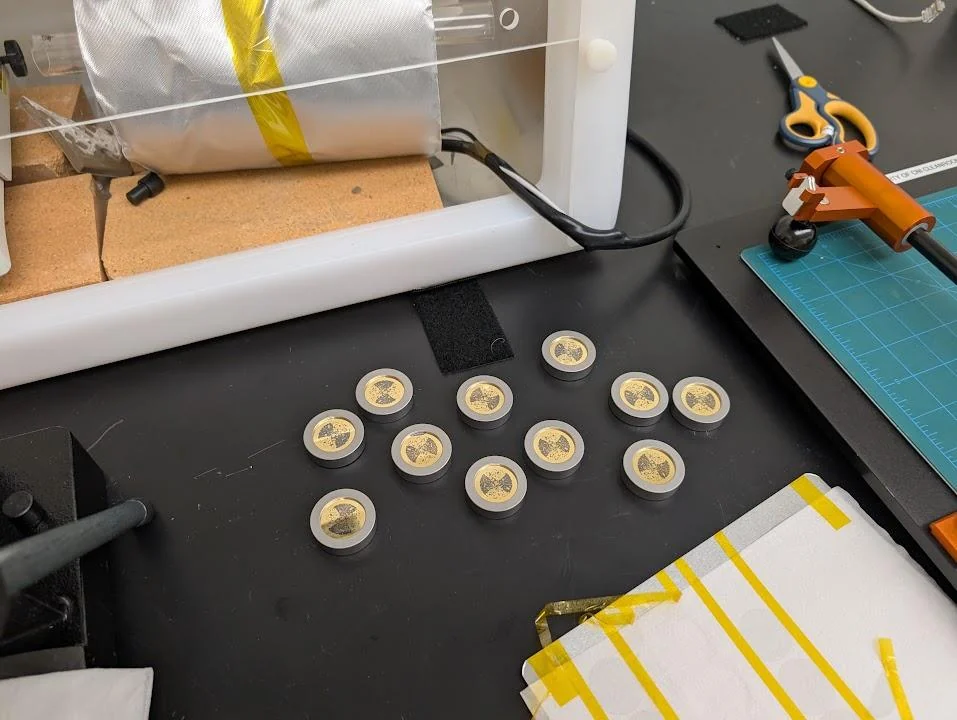 A batch of circular Pocket fiche samples on a laboratory bench