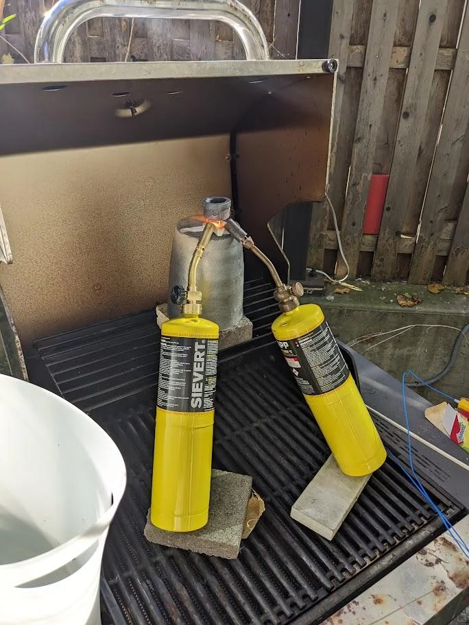 Two gas torches positioned around a quartz tube